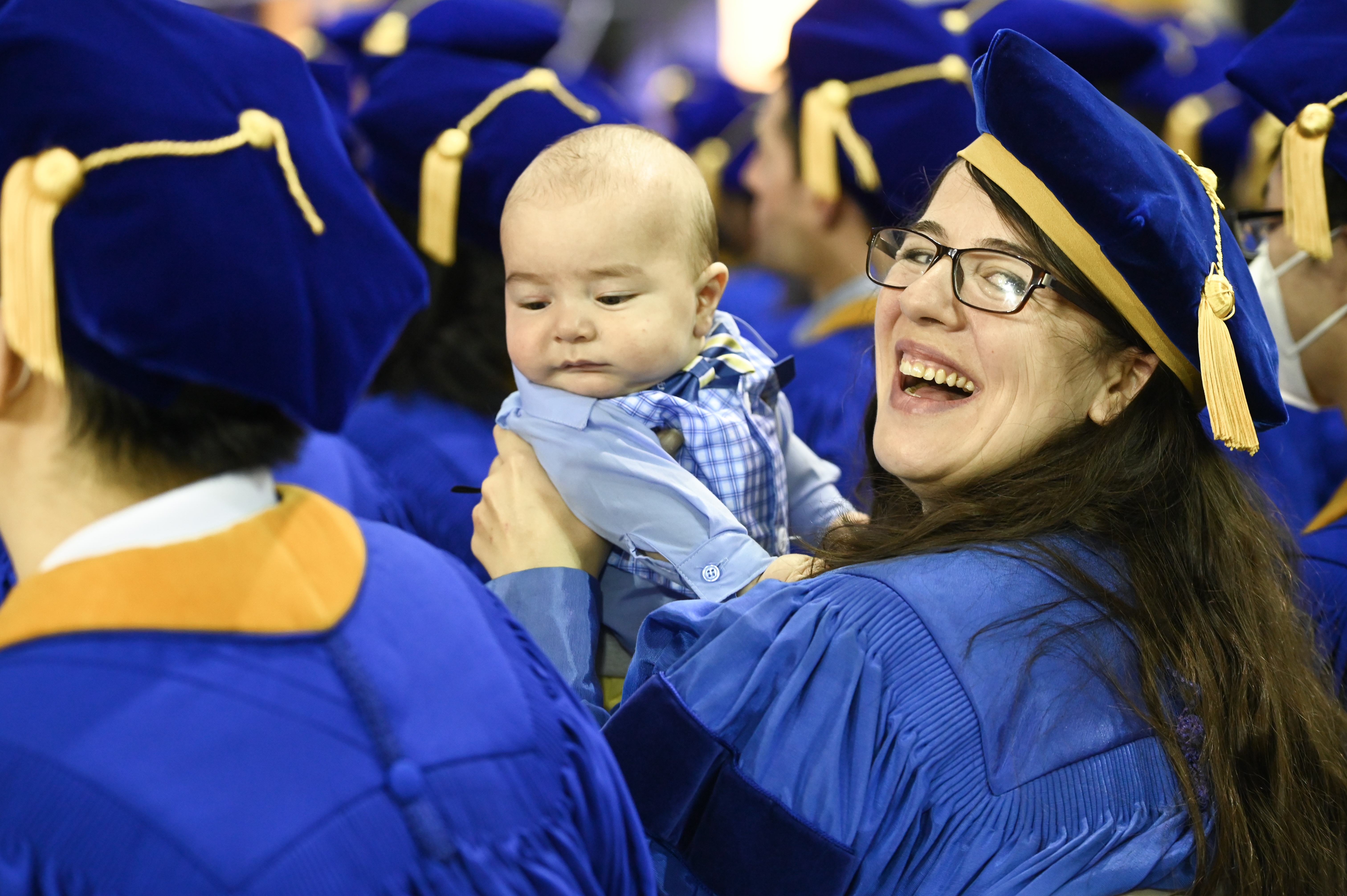 graduate with baby smiling 