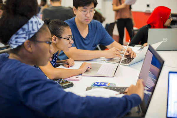 Students studying on their laptops in a data science course